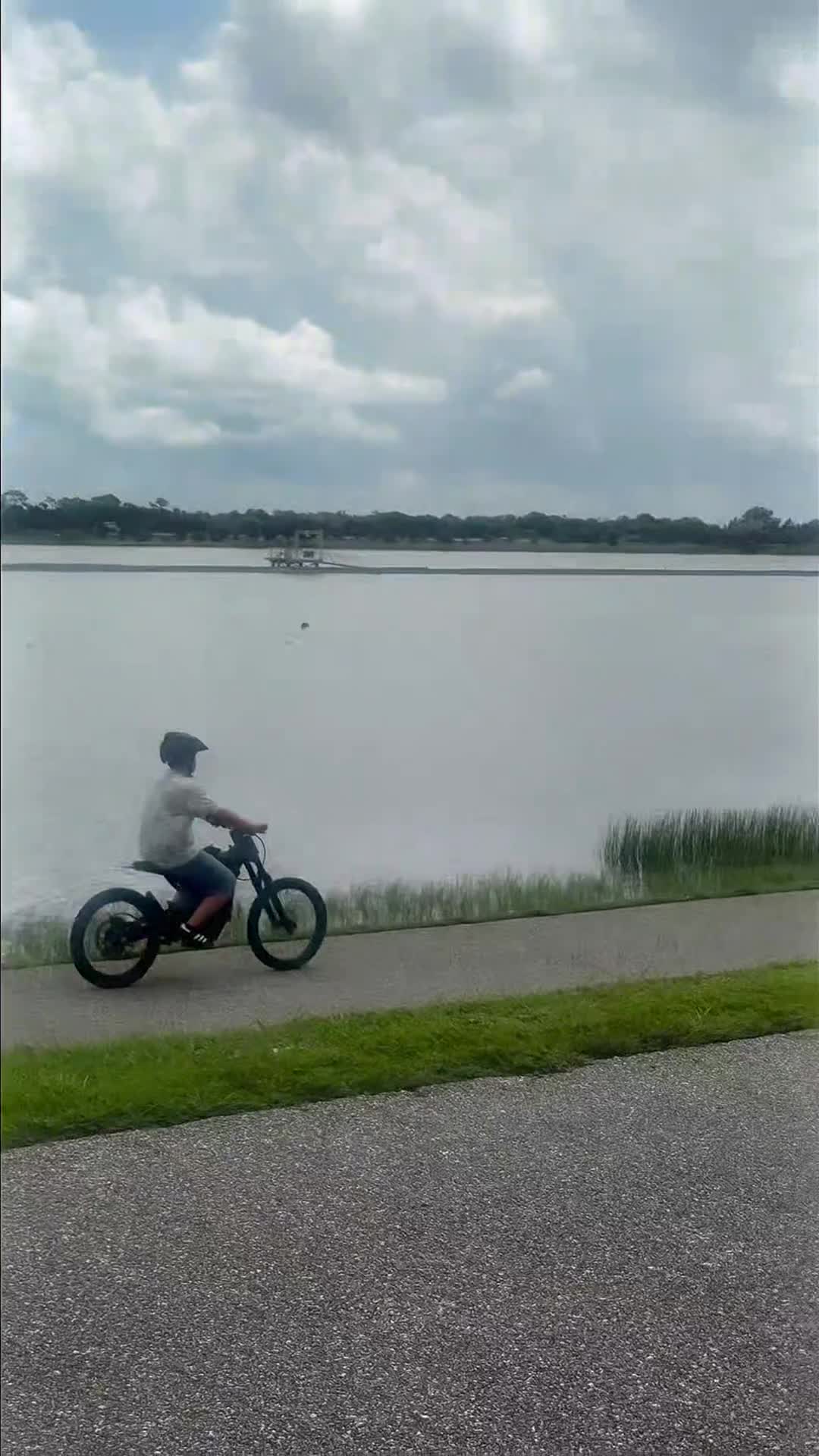 Cyclist riding beside the lake at Nathan Benderson Park in Sarasota